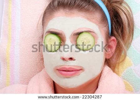 A beautiful young brunette woman having a chocolate face mask
