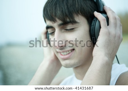 Young man  listen to music