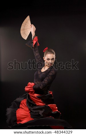 Attractive spanish dancer over black background