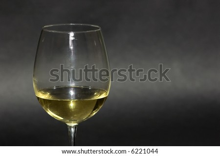 Detail of a white Italian wine glass on black background. Great aperitif