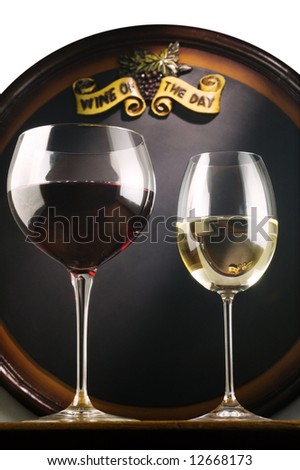 Red and white wine in fine glasses in front of an old blackboard isolated on white background. Wine of the day.