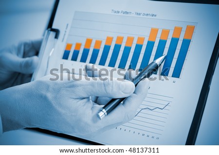 Businessman hand showing growing chart on annual report, good business growth