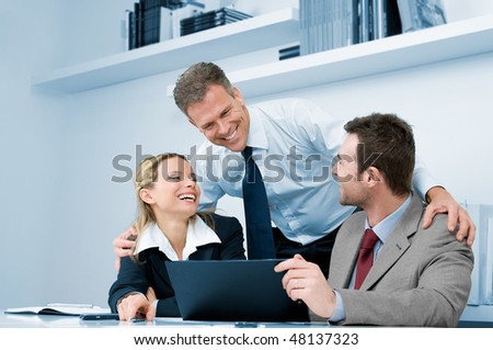 Happy business team working together during a meeting in office with satisfaction