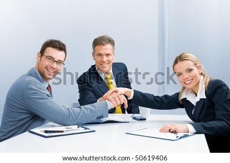 Happy smiling business team holding hands in a heap, good teamwork work