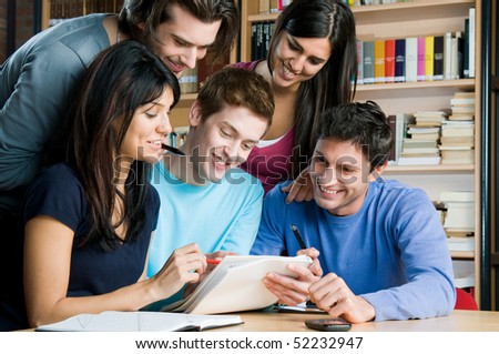 Happy group of students studying and working together in a college library
