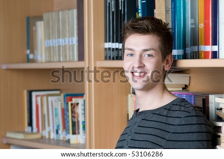 Happy smiling student in a college library looking at camera