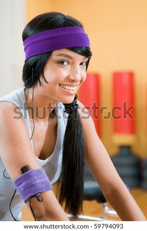 stock photo Smiling beautiful latin girl listening music during fitness