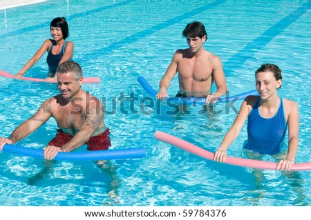 Healthy group of people exercising with aqua tube in a swimming pool