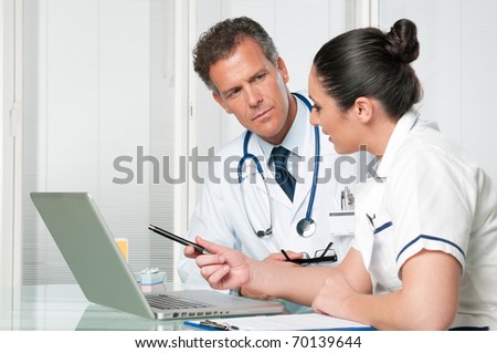 Mature doctor and his female discussing together a medical exam at clinic hospital
