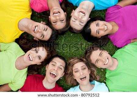 Happy joyful group of young friends enjoy together the life outdoor