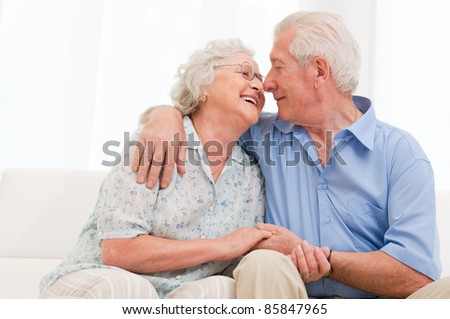 Happy joyful aged couple loving and enjoy the retirement at home