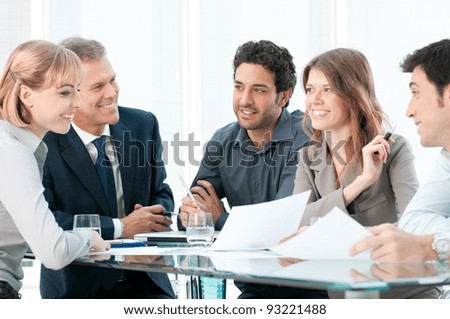 Group of business people working and discussing together at office