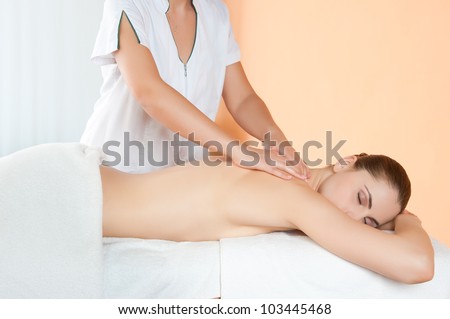 Relaxing hand massage on back at beauty spa salon