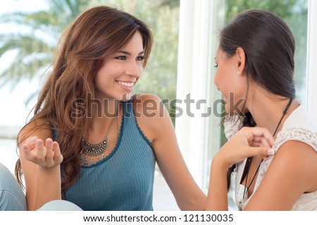 Two Happy Beautiful Women In Conversation