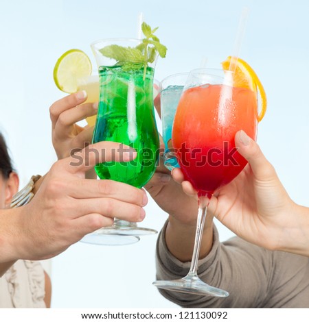 Group Of Happy Friends Celebrating Toasting With Glasses Of Cocktails