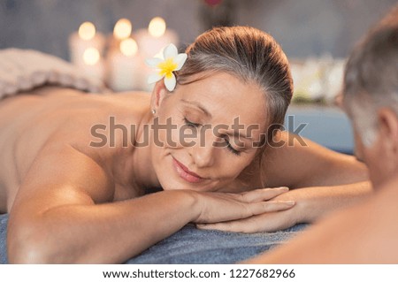 Senior woman resting at spa center after body therapy. Smiling mature couple relaxing at wellness center. Closeup face of woman relaxing with closed eyes after beauty treatment with her husband.