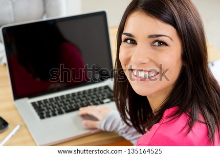 Close-Up Of Happy Student Girl Working On Laptop