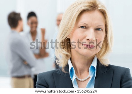 Portrait Of Happy Senior Businesswoman In Office