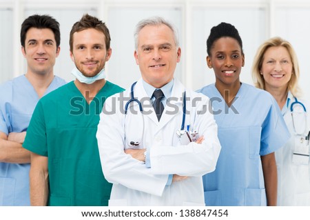 Smiling Team Of Doctors And Nurses At Hospital