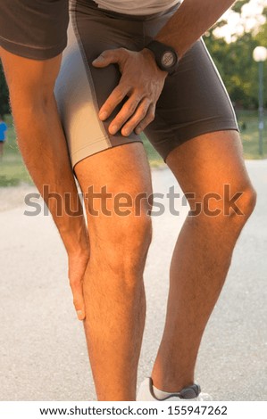 Male Athlete Suffering From Pain In Leg While Exercising
