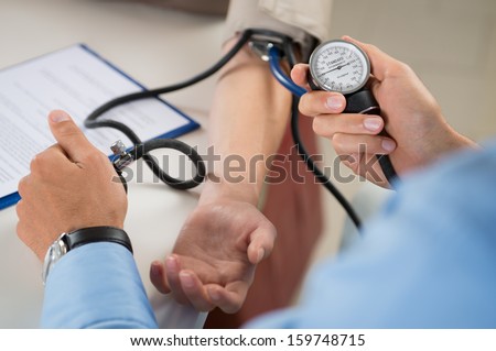 Close Up Of A Doctor Checking Blood Pressure Of A Patient