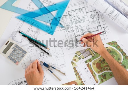 Close Up Of A Draftsman Drawing Diagram On Blueprints