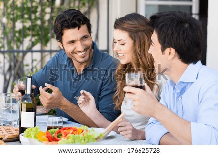 Group Of Happy Friends Having Dinner At Patio Outdoor
