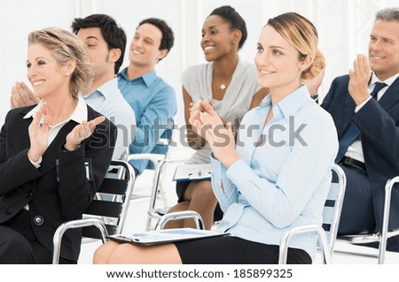 Group Of Happy Multiracial Businesspeople Clapping At Seminar