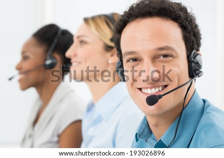 Happy Customer With Headsets Working With Other Colleague In Call Center