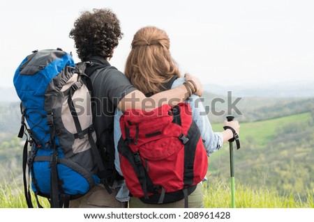 Portrait Of Hikers With Backpack And Hiking Pole Contemplate The Panorama