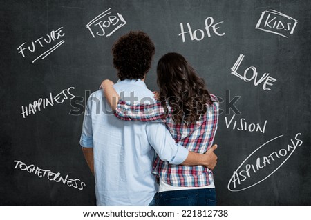 Young Couple With Arm Around Each Other Hope For a Better Future Over Gray Background