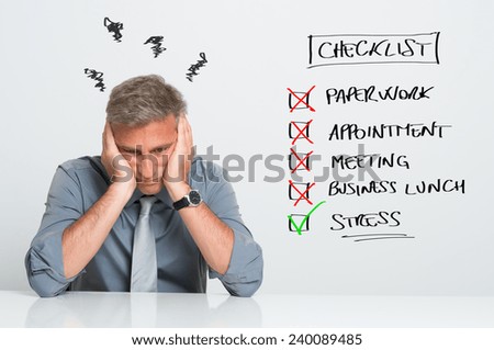 Portrait Of Stressed Businessman With Too Many Tasks To Do At Office