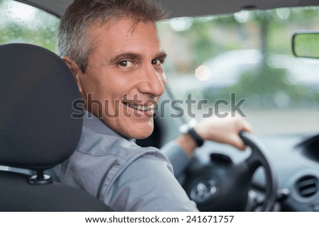 Portrait Of A Happy Mature Businessman Driving Car To Go To Work