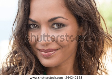 Close Up Of Young Woman Face Smiling Looking at Camera Outdoor