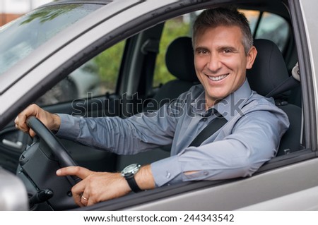 Closeup Of A Smiling Mature Businessman Parking The Car