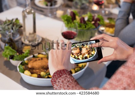 Close up of woman hands clicking picture of food. Woman using smartphone for food photography. Close up of female hands taking photo of roasted chiken with smart phone.