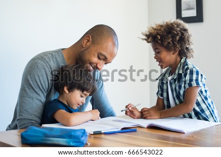 Young black father helping his boys with homework. Multiethnic brothers studying with their dad at home. Two cute children doing homeworks with the help of their loving parent.