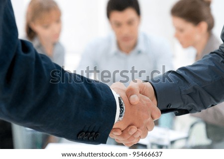 Business men shaking hands after an agreement during a meeting