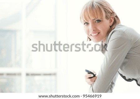Beautiful business woman smiling and looking at camera in a modern office