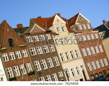 Old typical facades of colorful buildings in the old center of Copenhagen on a sunny day