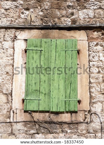 An old green window shutter seen in the old center of Split in Croatia