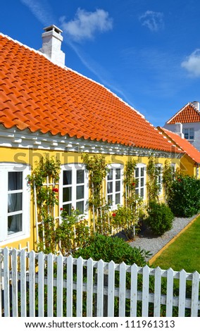 Small characteristic yellow house in the center of Skagen in jutland