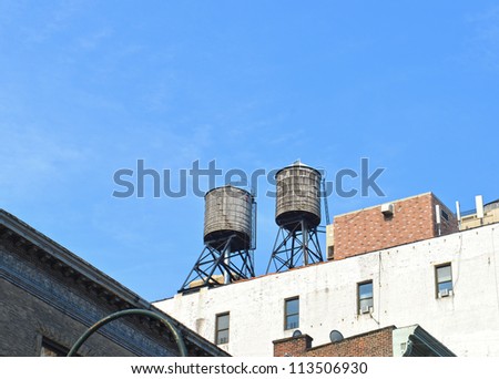 Two Rooftop water tanks on a New York apartment building