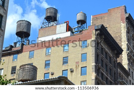 Two Rooftop water tanks on a New York apartment building