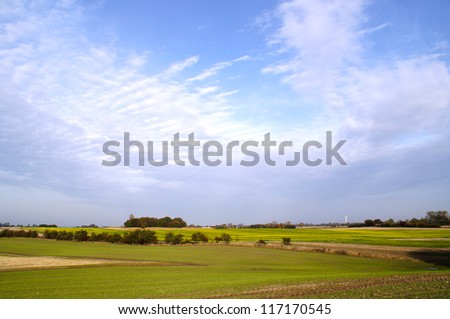 Blue sky and green field on a sunny day in the area close to Ringsted in Denmark