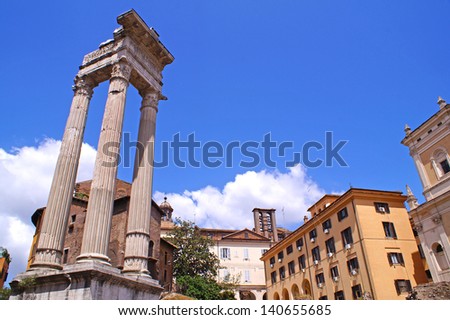 Ruins from the ancient Rome seen next to houses and apartments in the very center of Rome on aq sunny day