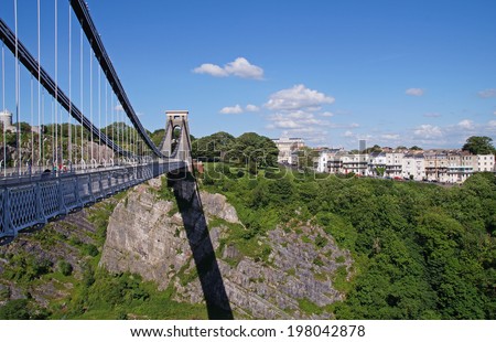 The Clifton Suspension Bridge from 1864 on a sunny day is crossing the Avon Gorge and the River Avon