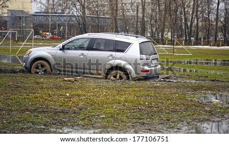 MOSCOW - APRIL 20: Car stuck in the mud Mitsubishi Outlander on April 20, 2013 in Moscow