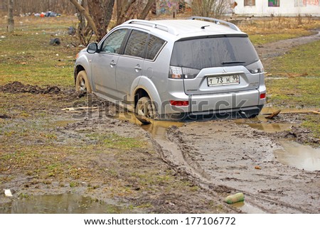 MOSCOW - APRIL 20: Car stuck in the mud Mitsubishi Outlander on April 20, 2013 in Moscow