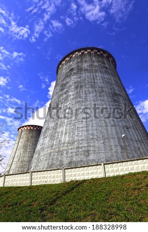 Large factory chimneys on blue sky background